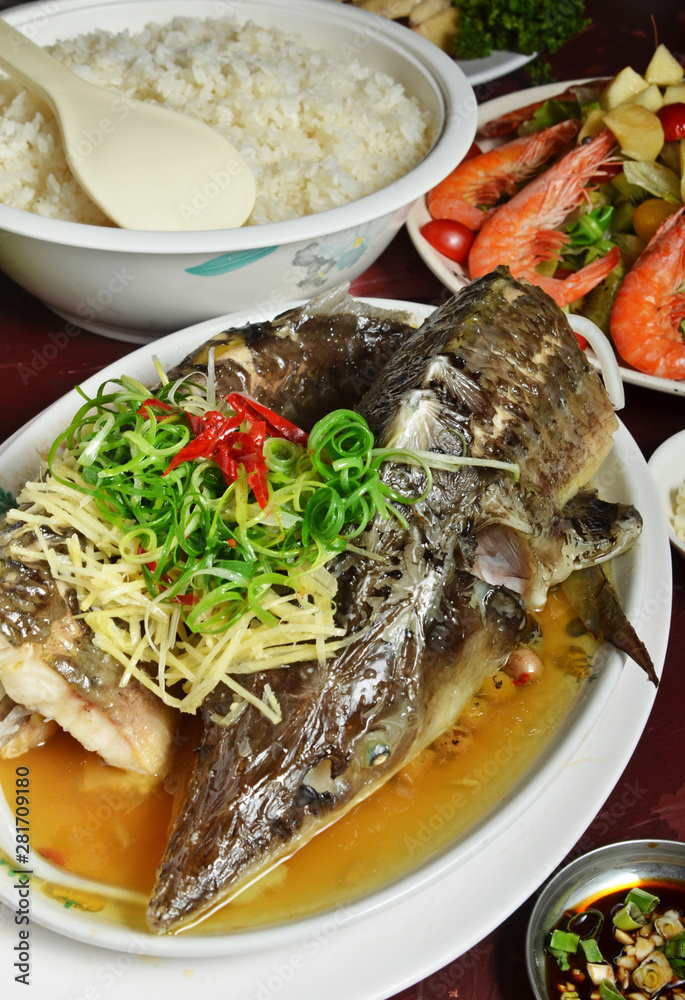 Steamed sturgeon with soya sauce, Chinese food menu. served on white plate Steamed sturgeon with soya sauce, Chinese food menu. served on white plate