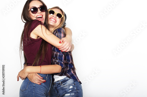 lifestyle, friendship and people concept: Two young girl friends standing together and having fun. Hipster style. © Raisa Kanareva