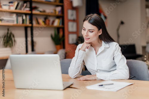 businesswoman in the office with laptop connects to clients online