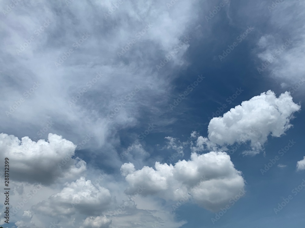 Obraz premium Beautiful white clouds with blue sky.Color shade gradient from white to blue for background wallpaper. 