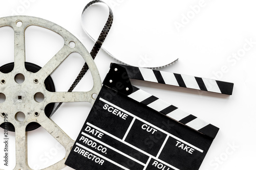 Fotótapéta Movie premiere concept with clapperboard, film type on white background top view