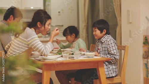 Family of four eating dinner