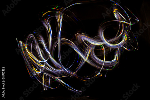 3d illustration. Abstract light painting on black background. Abstract art of iridescent grilling colors. Long exposure