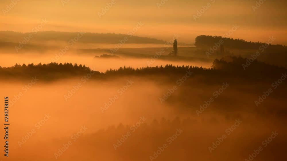 Hills covered in fog at sunrise Hills covered in fog at sunrise