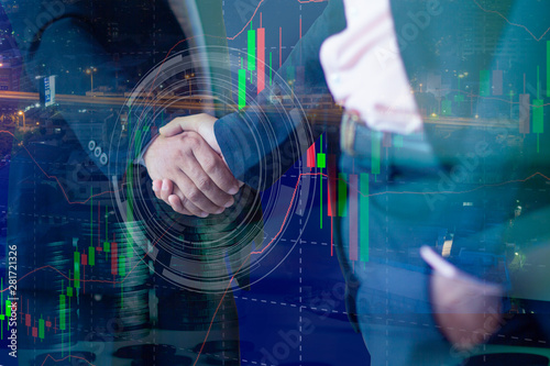 Double exposure businessmen shaking hands on abstract city and forex chart background.