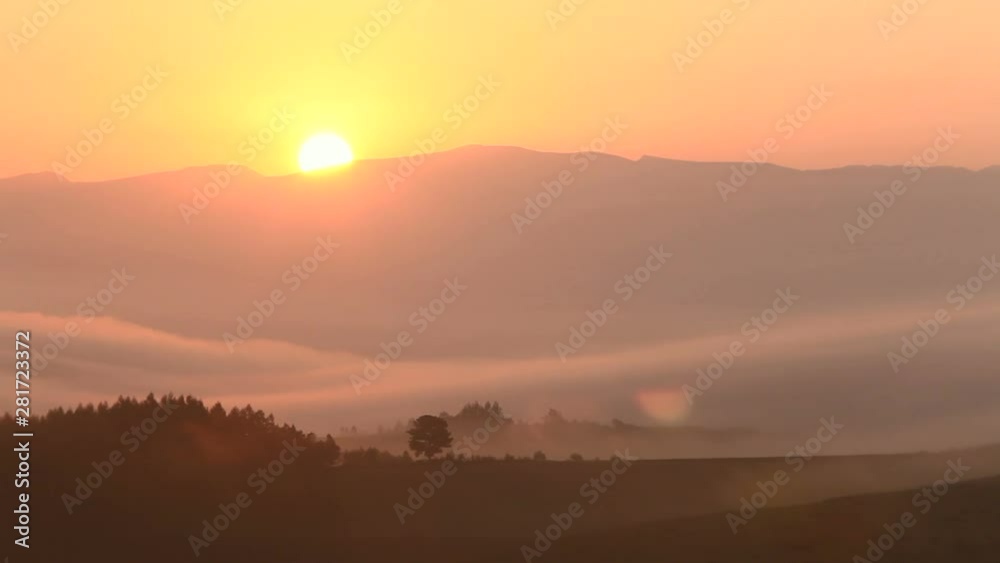 Timelapse of sun rising over hills shrouded in thick fog Timelapse of sun rising over hills shrouded in thick fog