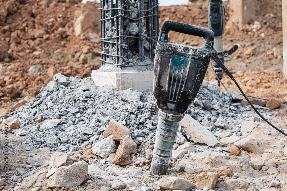 Jackhammer stand vertically at bridge construction site repair. Stock