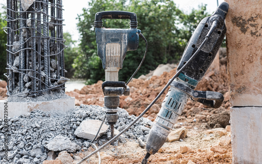 Jackhammer stand vertically at bridge construction site repair. Stock