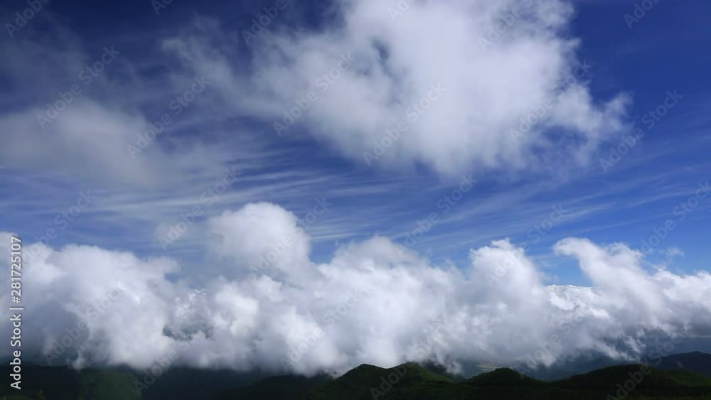 Clouds in sky flowing above mountains, Japan Clouds in sky flowing above mountains, Japan