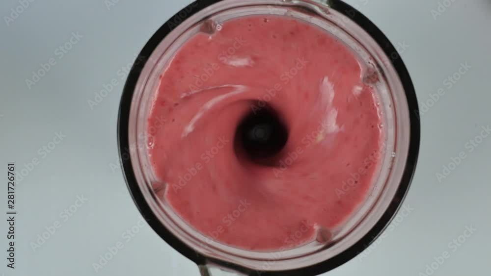 young woman cooking a fruit and berry cocktail in a blender. healthy eating, cooking, vegetarian food, dieting concept. top view 4K young woman cooking a fruit and berry cocktail in a blender. healthy eating, cooking, vegetarian food, dieting concept. top view 4K