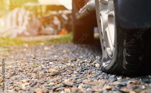 flat tire of old car park on the street , copy space, vintage color