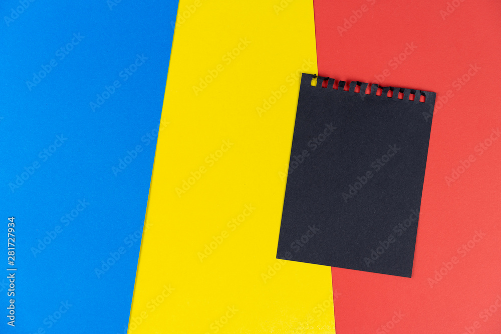 Plakat Black list Romania. Mourning, ban, sanctions, politics. black sheet of notebook lies on Romanian flag. Mock up, copy space, pattern, cardboard texture.