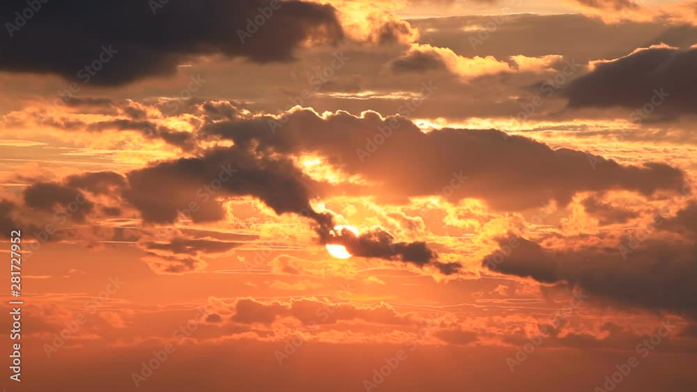 Setting sun and flowing clouds in sky Setting sun and flowing clouds in sky