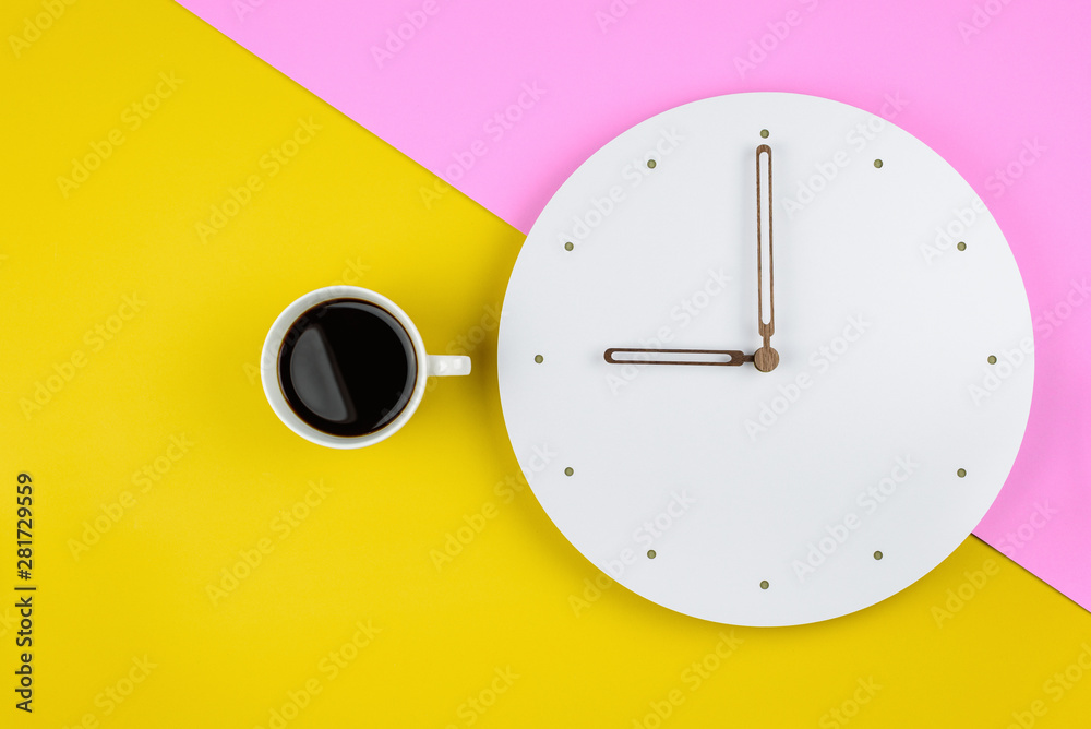Leisure, relax or coffee break, time for refreshment concept : Top or above view / flat lay of a cup of black coffee, white clock on pink-yellow background, depicts a rest period during business day Leisure, relax or coffee break, time for refreshment concept : Top or above view / flat lay of a cup of black coffee, white clock on pink-yellow background, depicts a rest period during business day