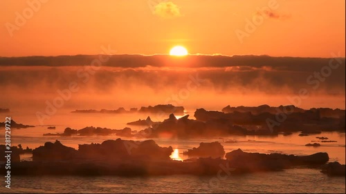 Icebergs on sea and steam above in sunrise, Yubetsu ,Hokkaido, Japan photo