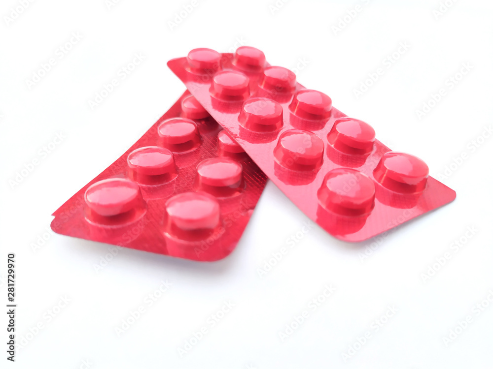 red medicine tablet isolated on white background red medicine tablet isolated on white background