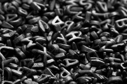 Texture with black letters. Scattered Alphabet