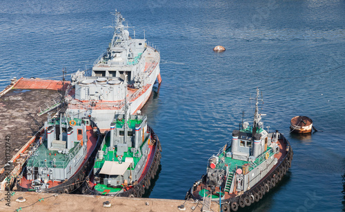 Tugboats and Military ships in Yuzhnaya Bay photo