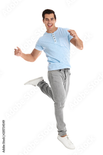 Handsome young man dancing on white background