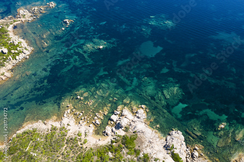 View from above, stunning aerial view of a green rocky coast bathed by a beautiful turquoise sea. Costa Smeralda (Emerald Coast) Sardinia, Italy. © Travel Wild