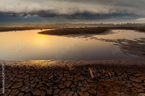 thunder storm sky Rain clouds Cracked dry land without wate photo