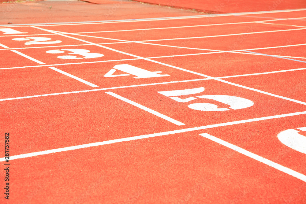 Start of red athletic track with numbers. Sport concept