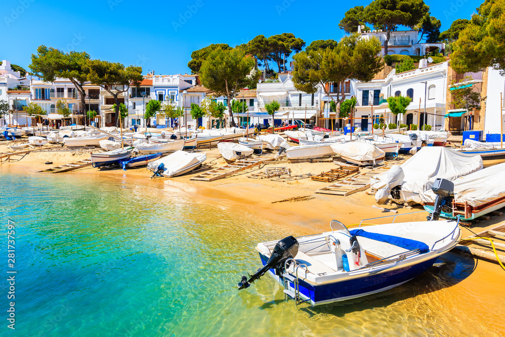 Traditional colorful fishing boats on beach in Llafranc port, Costa Brava, Spain