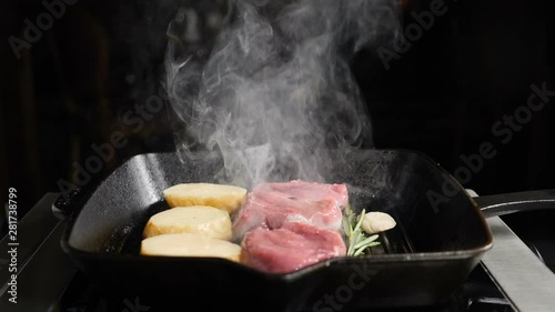 Super slowmotion food cooking footage. Potato and meat cooked on grill. Chef in restaurant cooking delicious grilled meat with white smoke. hd