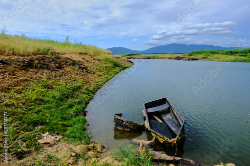 Old boat is getting drowned in water.