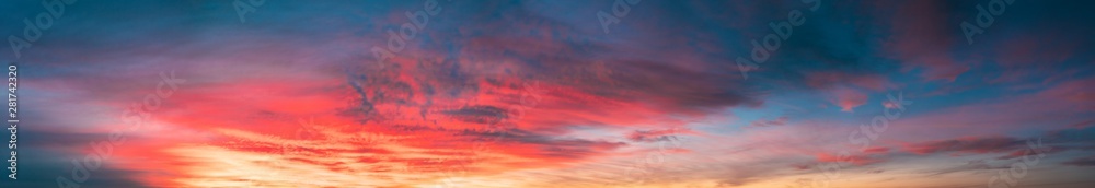 Sunrise Sky Cloudscape. Natural Bright Dramatic Sky In Sunset Dawn. Yellow, Blue And Orange Sky Colors Above Dark Ground.