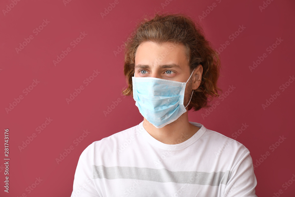 Young man wearing protective mask on color background Young man wearing protective mask on color background