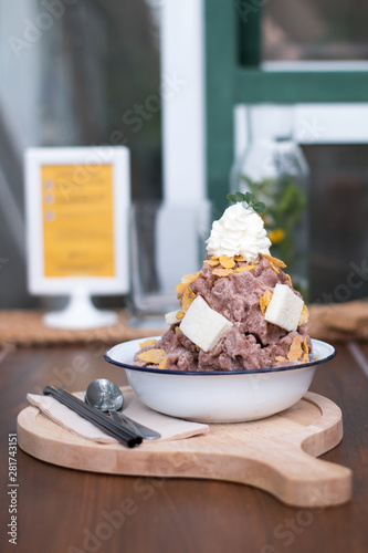 Snow ice cream cocoa dessert with milk sauce, bread, corn flake and whip cream topping
