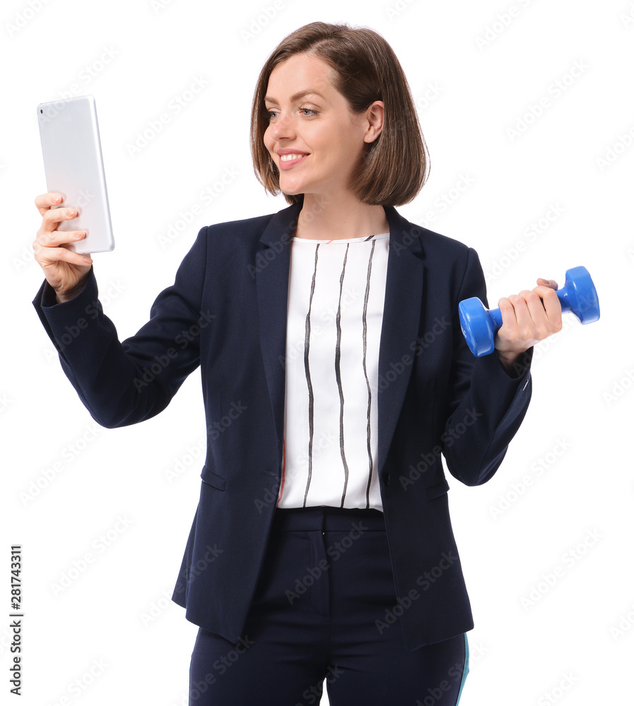 Young businesswoman with tablet PC and dumbbell on white background. Concept of balance between work and leisure Young businesswoman with tablet PC and dumbbell on white background. Concept of balance between work and leisure
