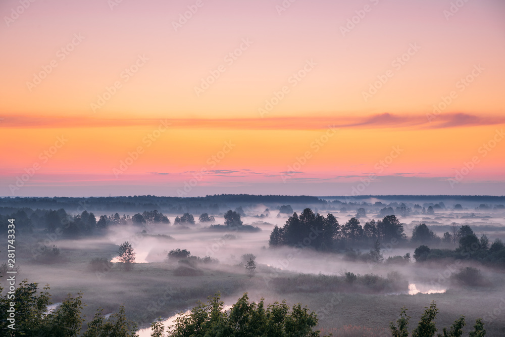 Amazing Sunrise Sunset Over Misty Landscape. Scenic View Of Foggy Morning Sky Above Misty Forest And River. Early Summer Nature Of Eastern Europe