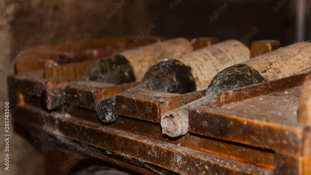Old And Dusty Wine Bottles In Cellar In Winery