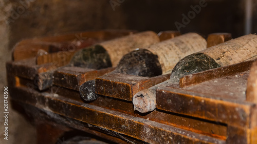 Old And Dusty Wine Bottles In Cellar In Winery