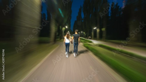 The couple walking in an evening park. hyperlapse photo