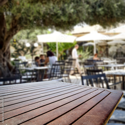 Table background  in a restaurant outdoor view. Empty  space for your decoration and an advertising product. © magdal3na