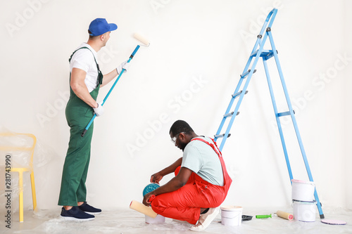 Male decorators painting li...