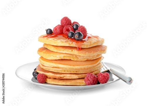 Plate with tasty pancakes and berries on white background photo
