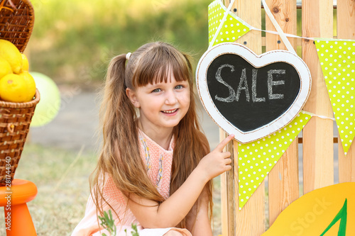 Cute little girl selling le...