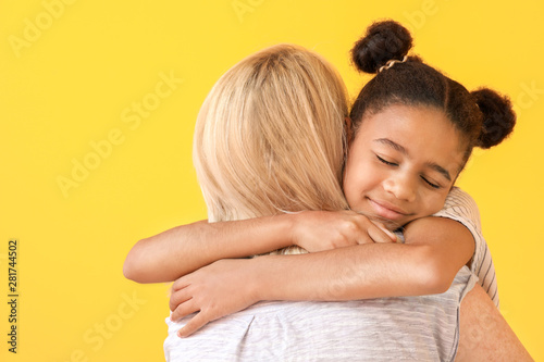 Happy woman hugging her Afr...