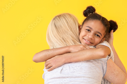 Happy woman hugging her Afr...