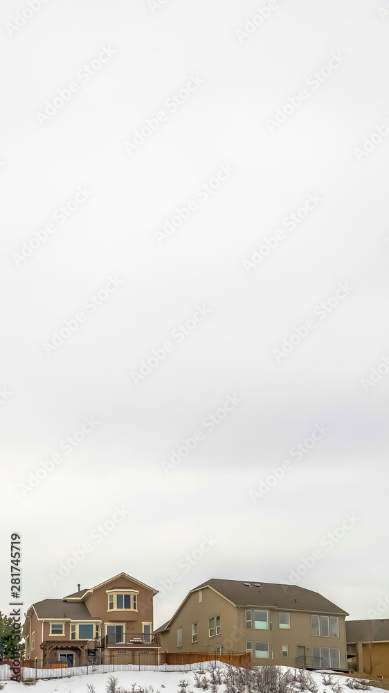 Vertical Multi storey houses on a hill under a vast overcast sky on a cold winter day