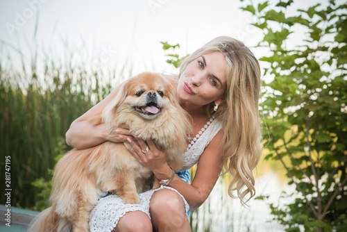 Pets concept. Nice girl with a golden at nature, enjoy the life 