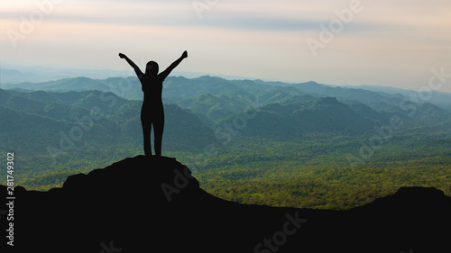 silhouette of woman on mountain top over sky and sun light background,business, success, leadership, achievement and people concept