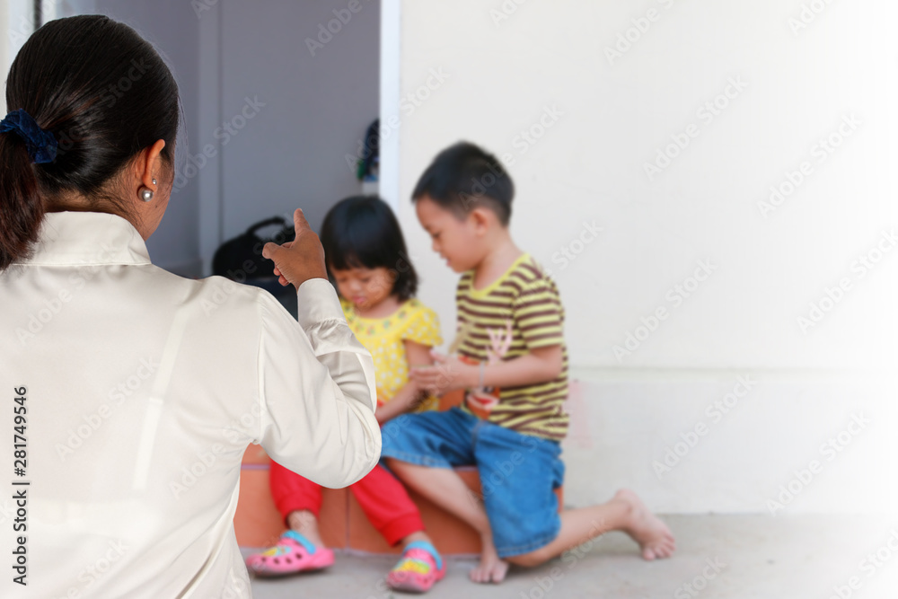 Mother scolds her child because of playing naughty and refusing to obey Mother scolds her child because of playing naughty and refusing to obey