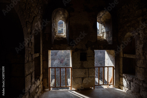 light illuminating the inside of an ancient temple through it overlooking the gorge on a sunny day.