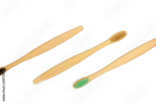 Top view of bamboo toothbrushes on white background.