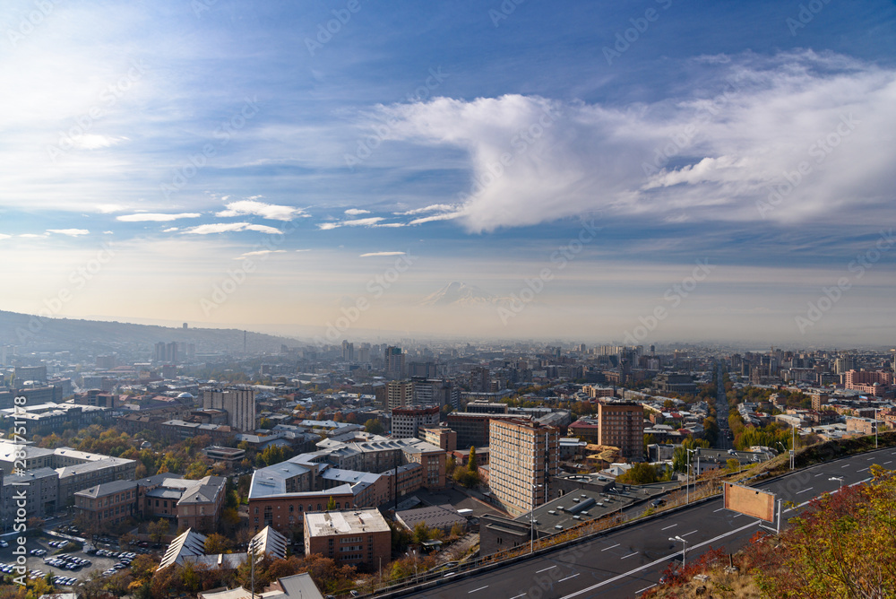 view of the city of Yerevan from the observation deck on a sunny day with clouds in the sky.